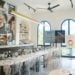 Perfume workshop room with a long bar table and arched windows at NOTE  The Scent Lab in Thao Dien