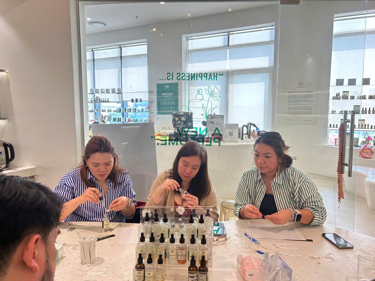 Corporate team at perfume workshop in Lotte Mall Hanoi — team building activity