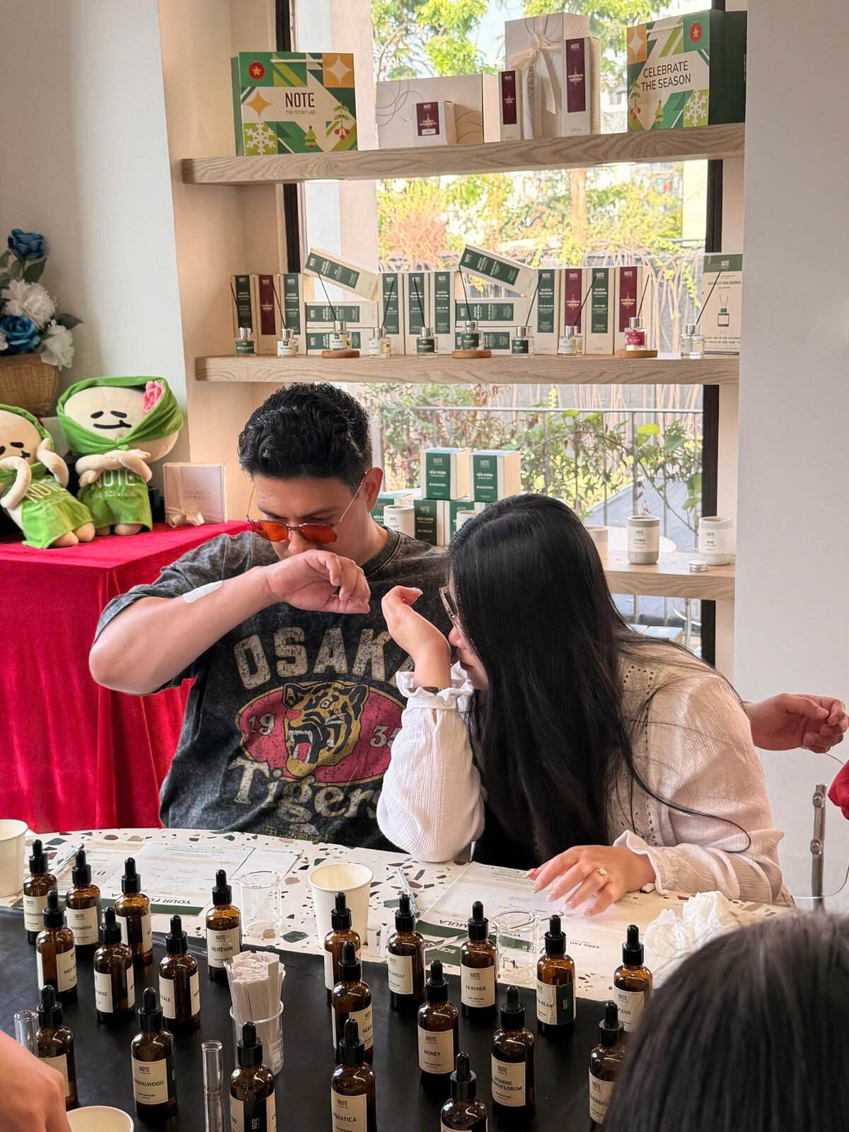 Couple smelling fragrance at NOTE perfume workshop Vietnam experience