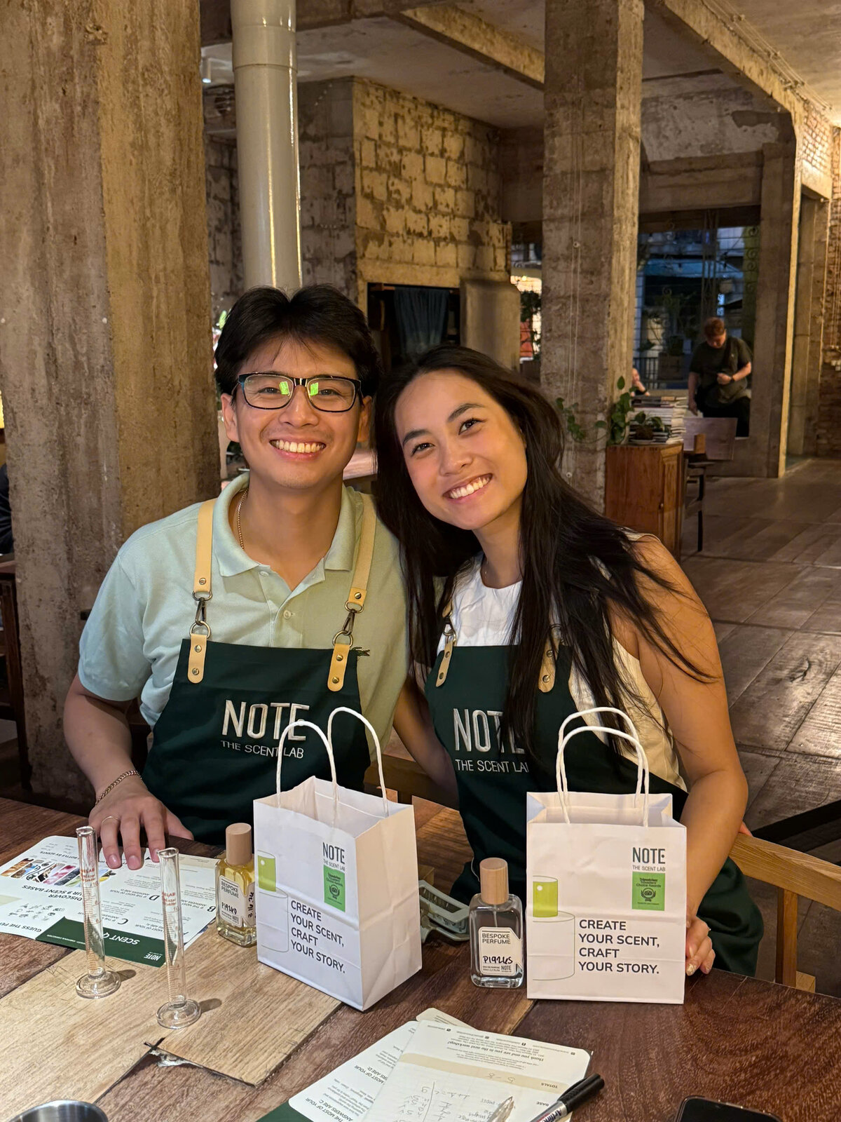 Couple with personalized perfume and NOTE bags at workshop Saigon
