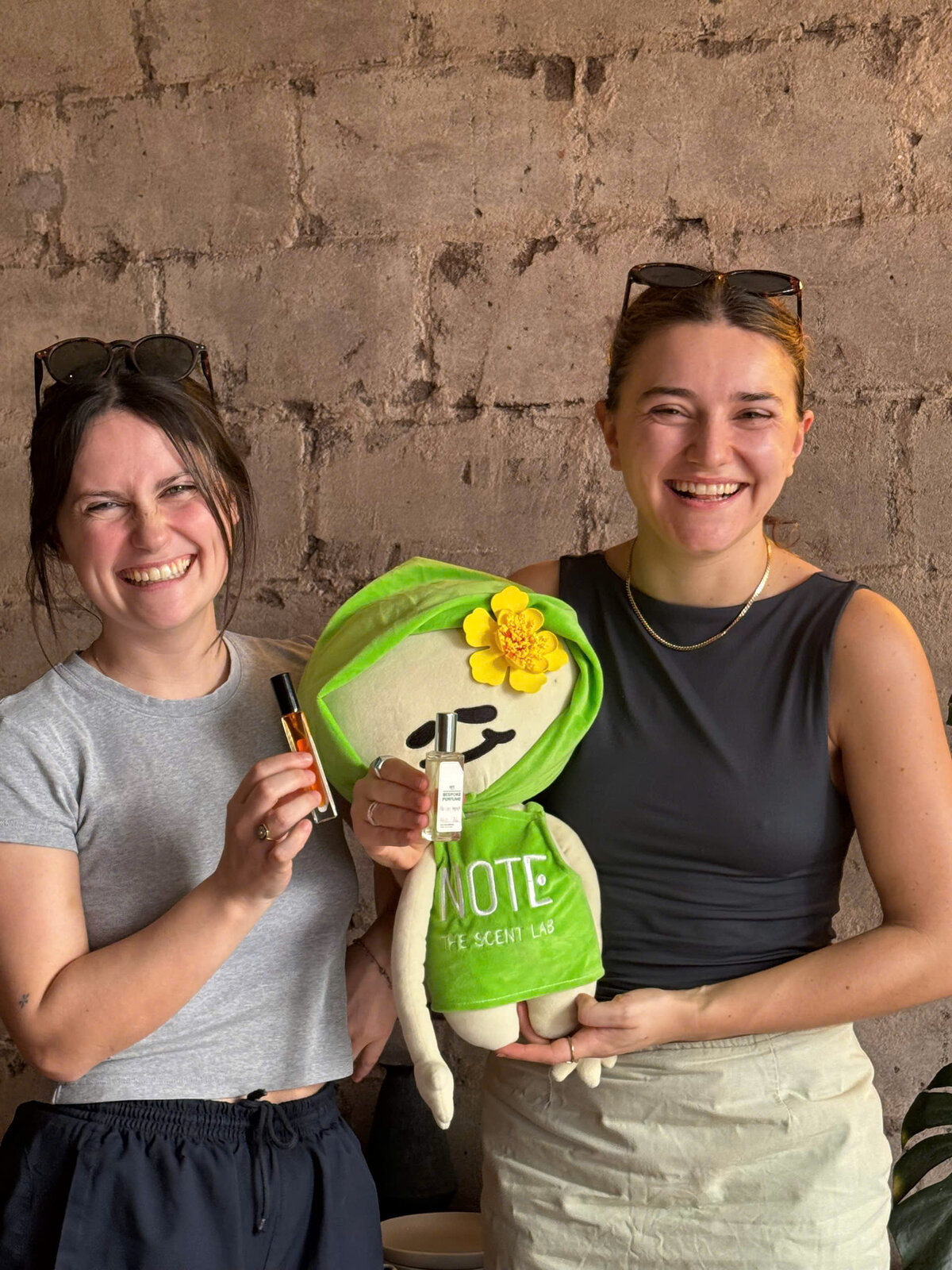 Friends with custom perfume souvenir and NOTE mascot — last day in Saigon