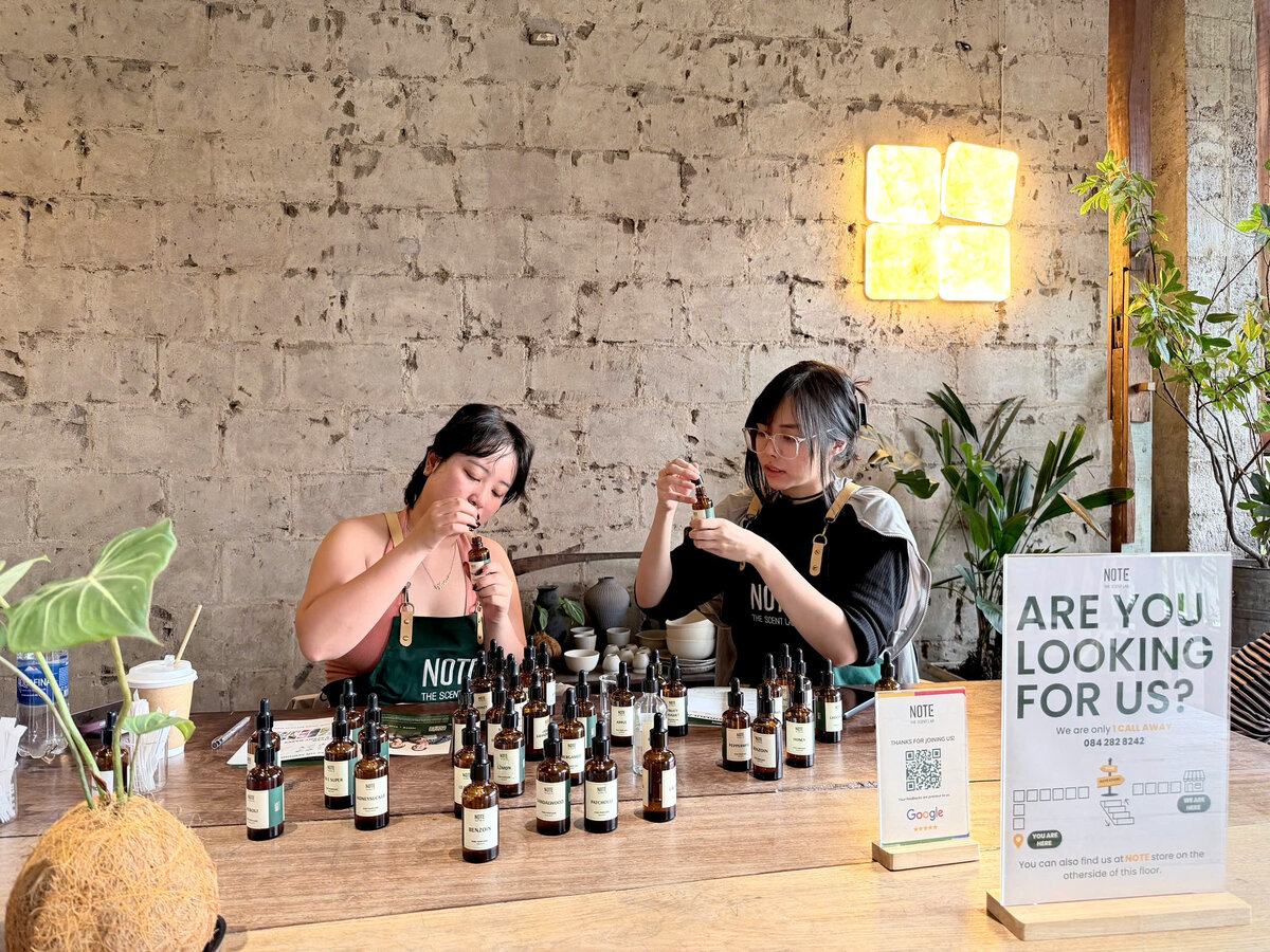 Visitors smelling fragrance notes at perfume workshop near Saigon Opera House