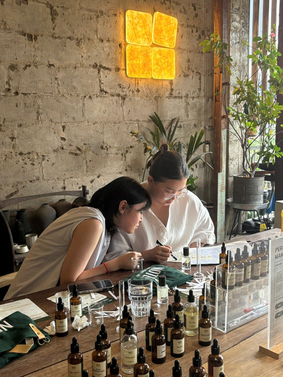 Workshop instructor guiding travelers at NOTE perfume workshop in Saigon