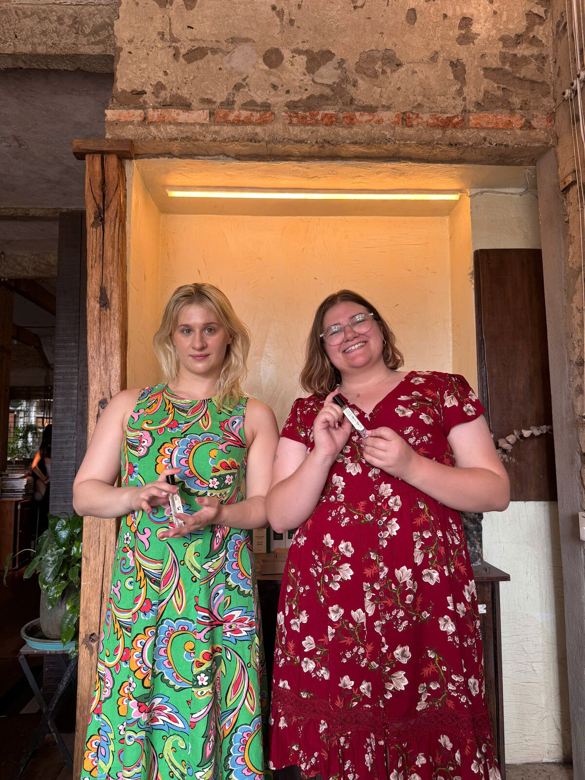 Travelers proudly showing custom perfume bottles after workshop