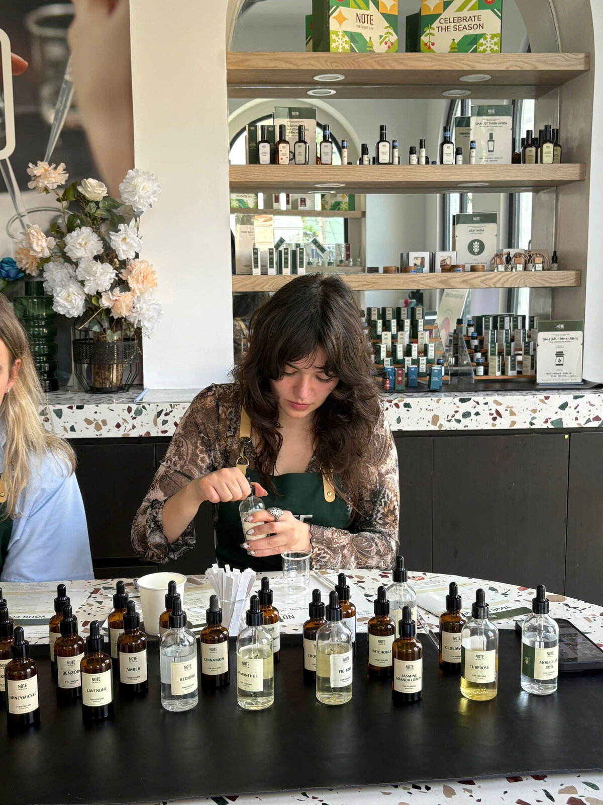 Traveler blending unique souvenir perfume at NOTE workshop in Saigon