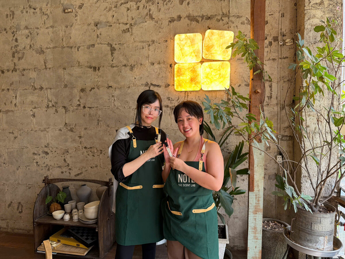 Friends with finished perfume bottles Saigon workshop