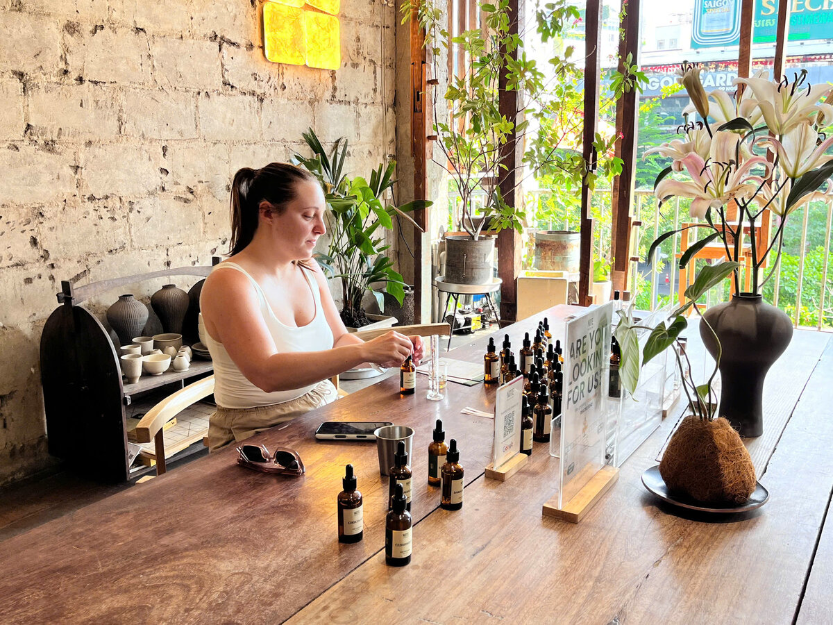 Solo traveler blending perfume at NOTE workshop in Saigon Cafe Apartment